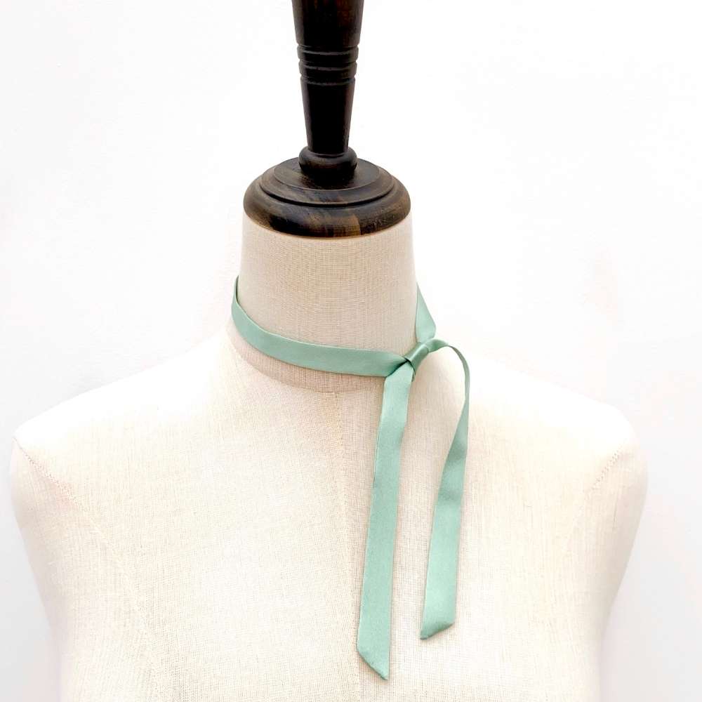 Mannequin wearing a Seafoam green mulberry silk satin ribbon scarf on a white background