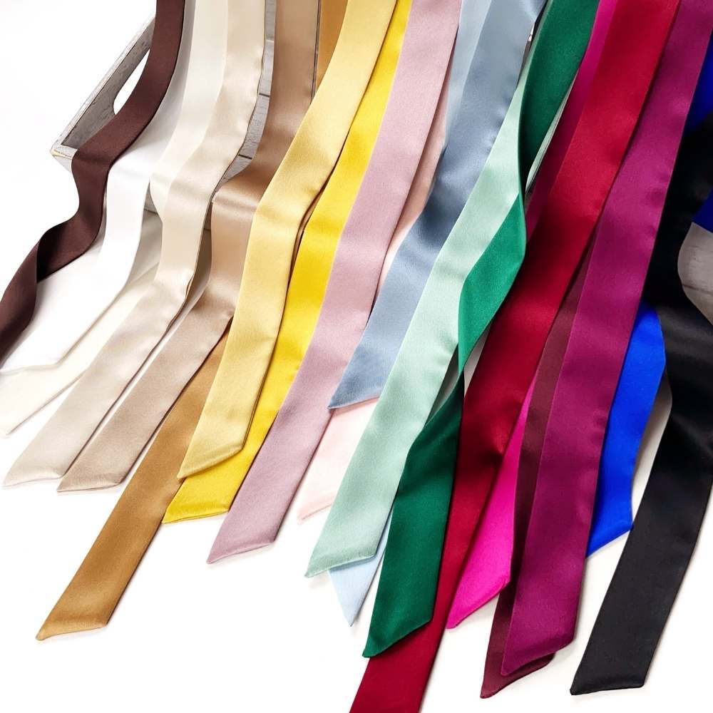Collection of colorful mulberry silk satin skinny scarf ribbons on a white background