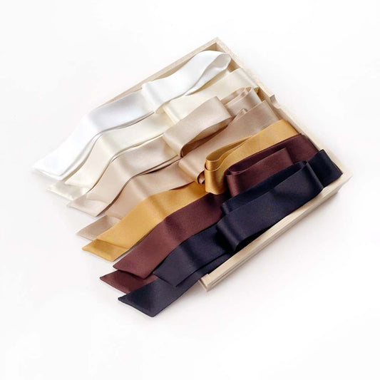 Set of mulberry silk satin skinny scarf ribbons in various colors on a white background