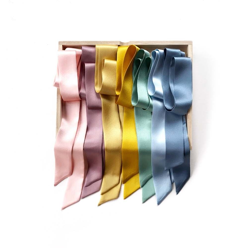 Set of mulberry silk satin skinny scarf ribbons in various colors on a white background