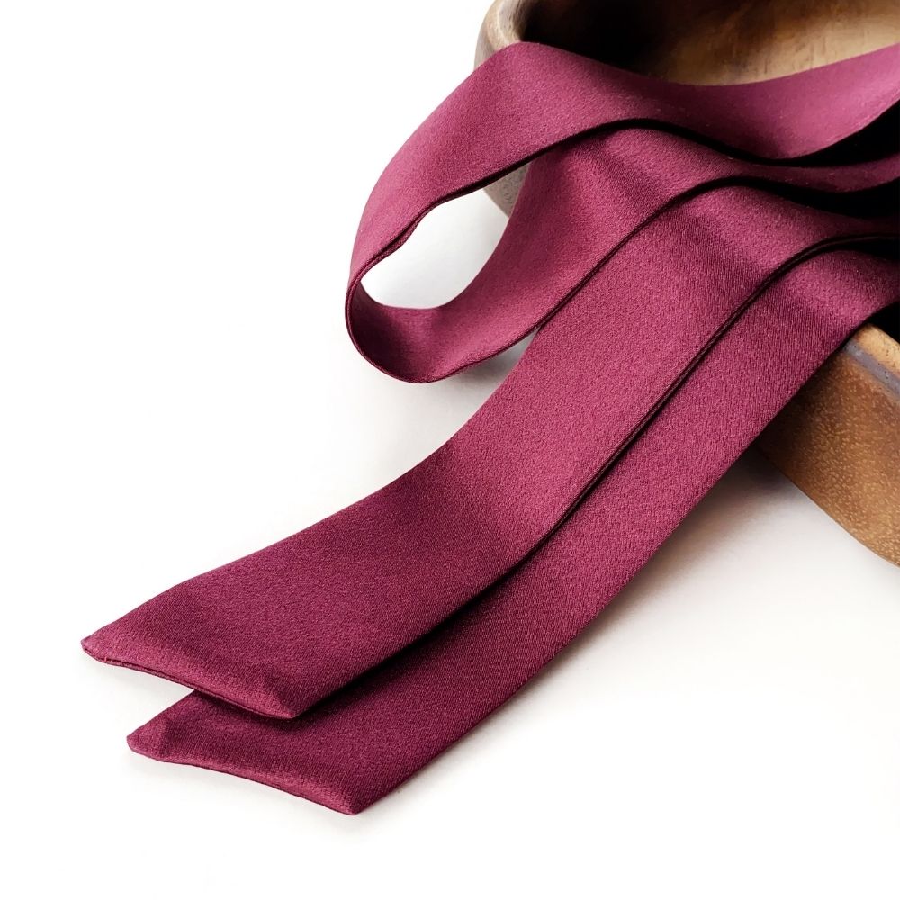 A deep burgundy mulberry silk skinny scarf
