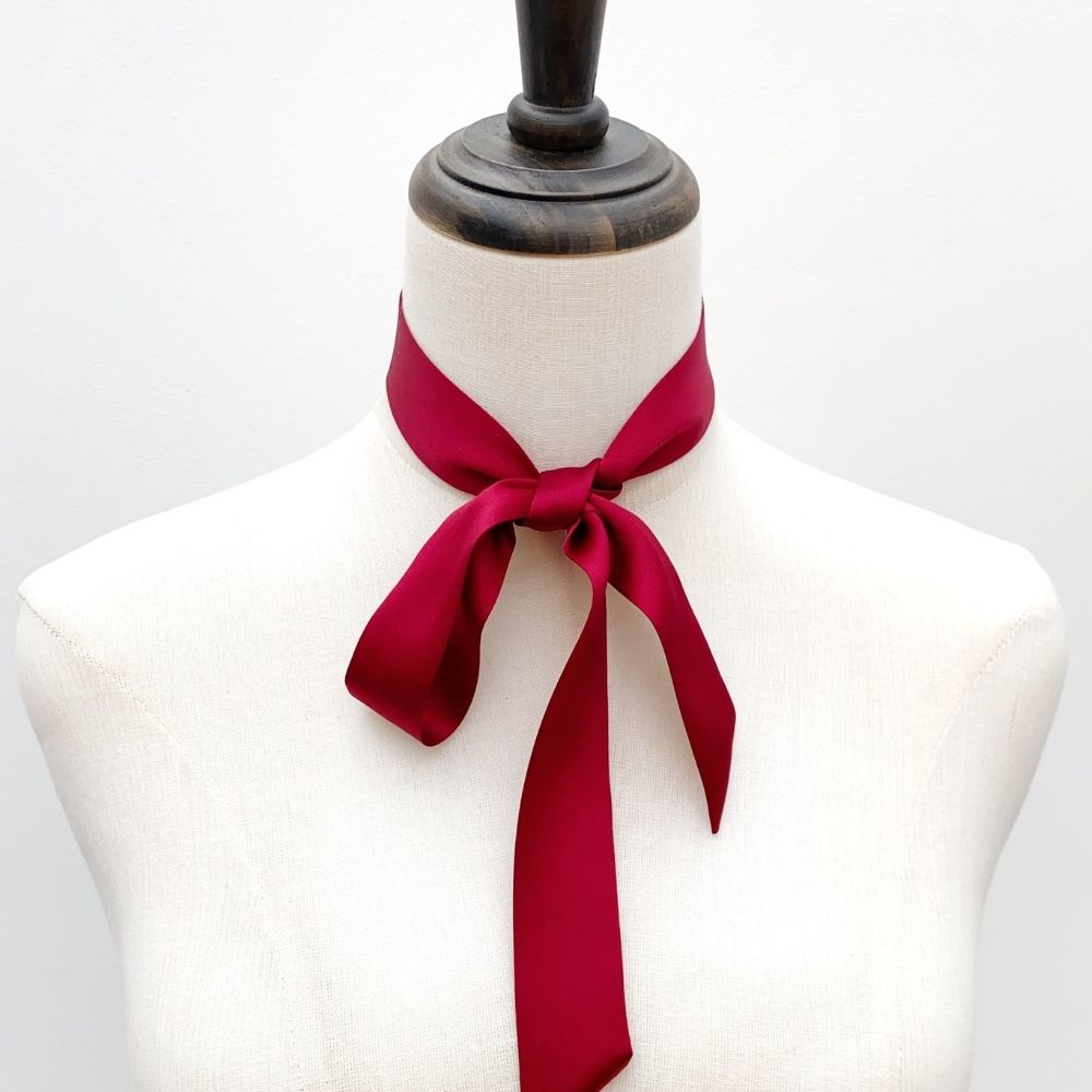 A deep red mulberry silk skinny scarf