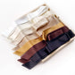A set of mulberry silk satin skinny scarves in multiple colors, including white, ivory cream, beige, gold, brown, and black