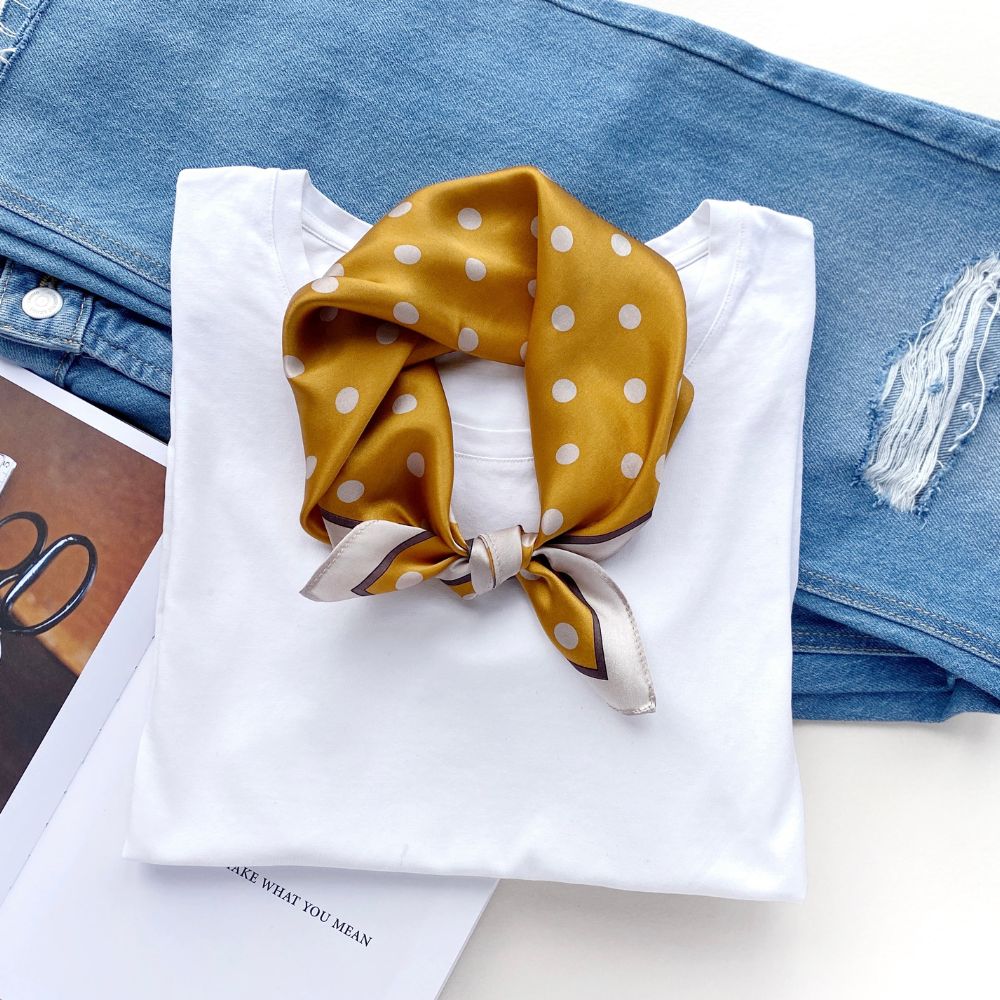 Mustard Yellow polka dots mulberry silk neck scarf on a white shirt with blue jeans