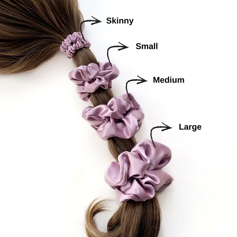 Purple silk scrunchies of different sizes on a ponytail with labeled sizes.