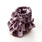 Set of purple pure mulberry silk satin scrunchies and hair ties on the white background.
