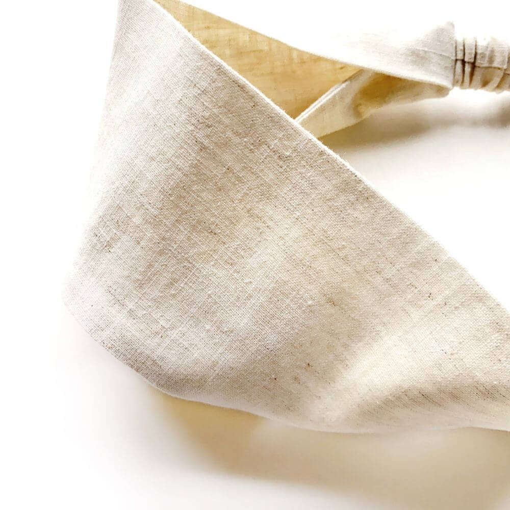 Close-up of natural linen headband on a white background