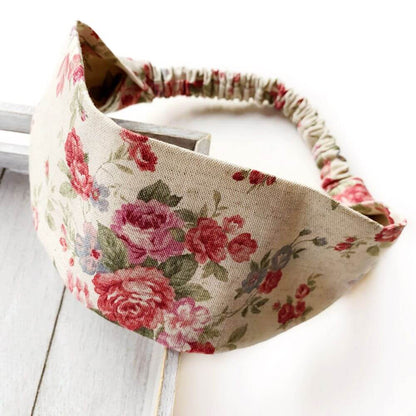 Natural coloured Cotton Linen rose floral patterned headband on a light wooden surface