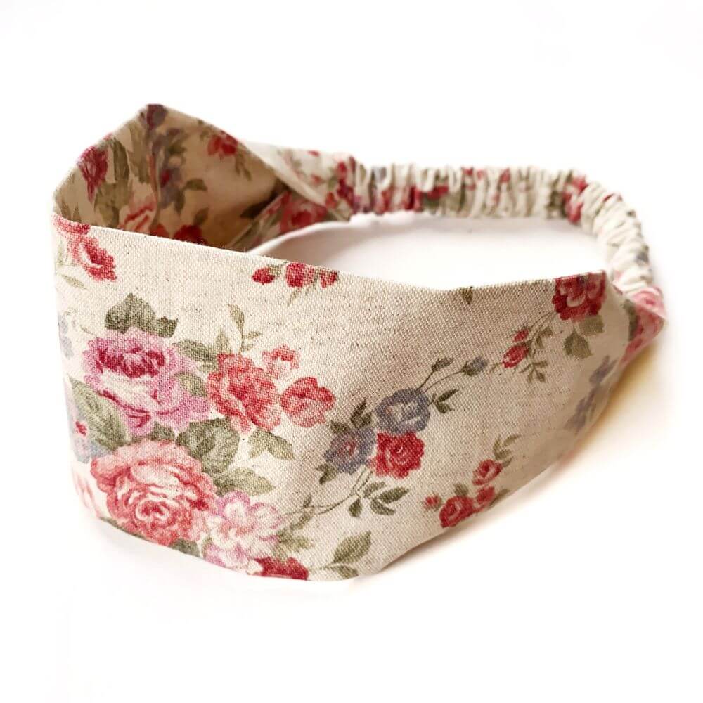 Natural Cotton Linen rose floral patterned headband on a white background.