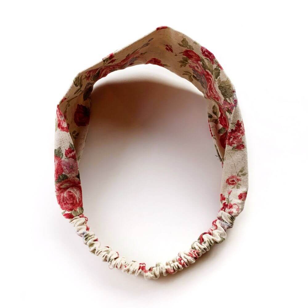 Natural Cotton Linen rose floral patterned headband on a white background.