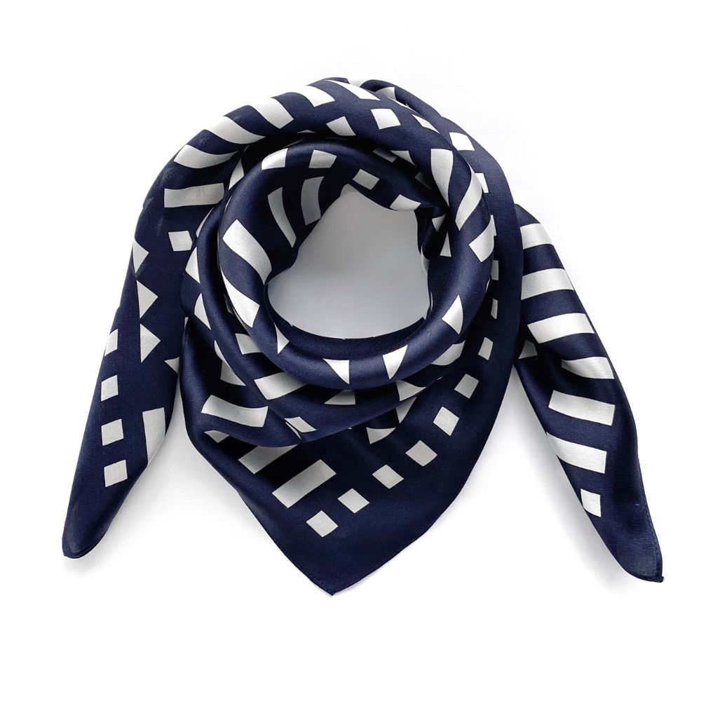Navy blue and white geometric mulberry silk square scarf on a white background