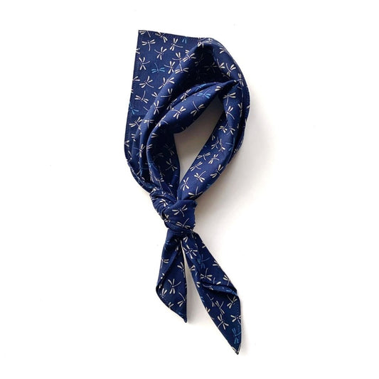 A navy blue dragonfly print japanese cotton square scarf, tied in a knot and displayed on a clean white background.