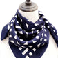 Navy blue silk scarf with white geometric pattern on a mannequin