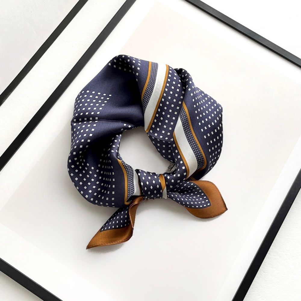 Navy blue and brown geometric patterned mulberry silk square neck scarf on a white background