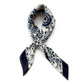 A blue and white geometric floral print mulberry silk neck scarf tied in a neat knot against a white background.