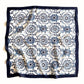 A full view of a square mulberry silk scarf featuring a blue and white geometric floral pattern with a solid navy border, laid flat on a white background.
