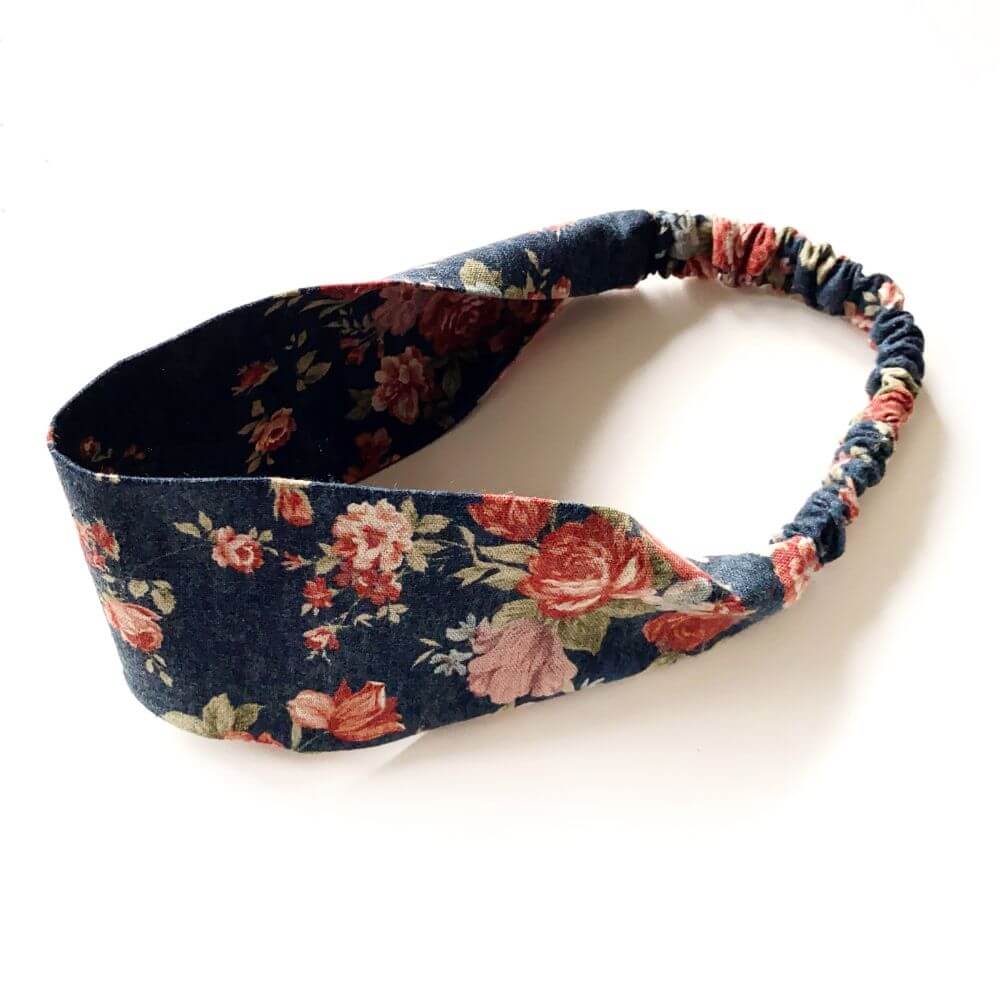 Navy rose floral patterned headband on a white background