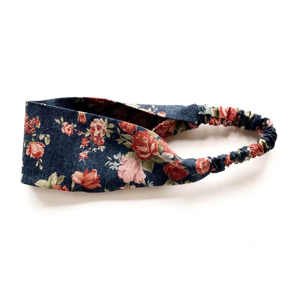 Navy rose floral patterned headband on a white background