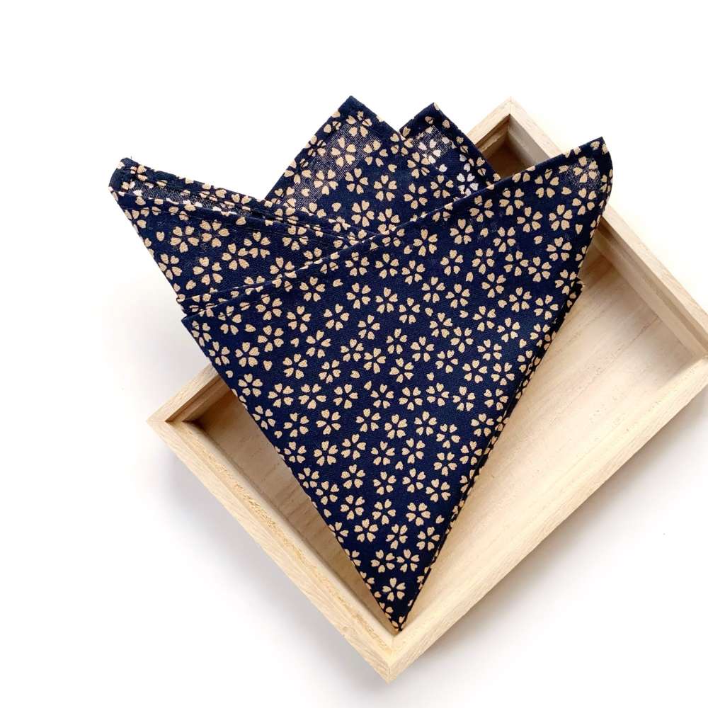 Navy blue Japanese cotton pocket square in a wooden box on a white background