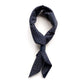Navy blue wave patterned cotton bandana scarf tied in a knot on a white background