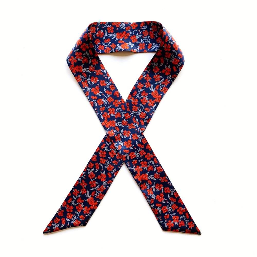 Floral patterned liberty silk skinny scarf on a white background