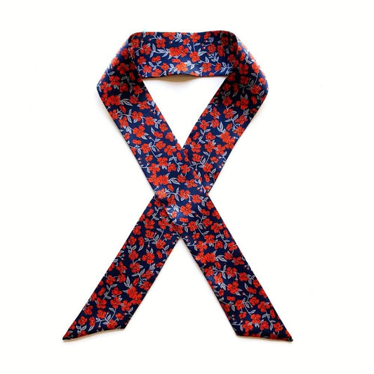 Floral patterned liberty silk skinny scarf on a white background