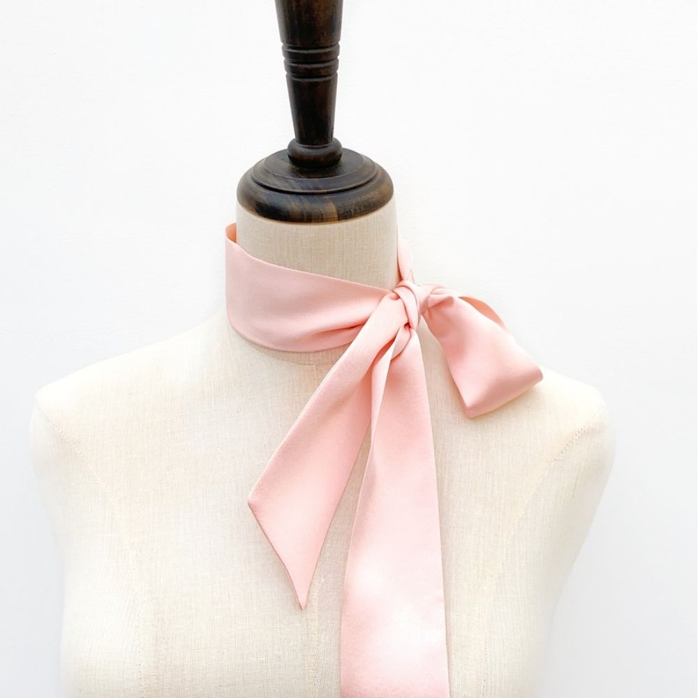 pastel pink mulberry silk satin skinny scarf tied around mannequin's neck