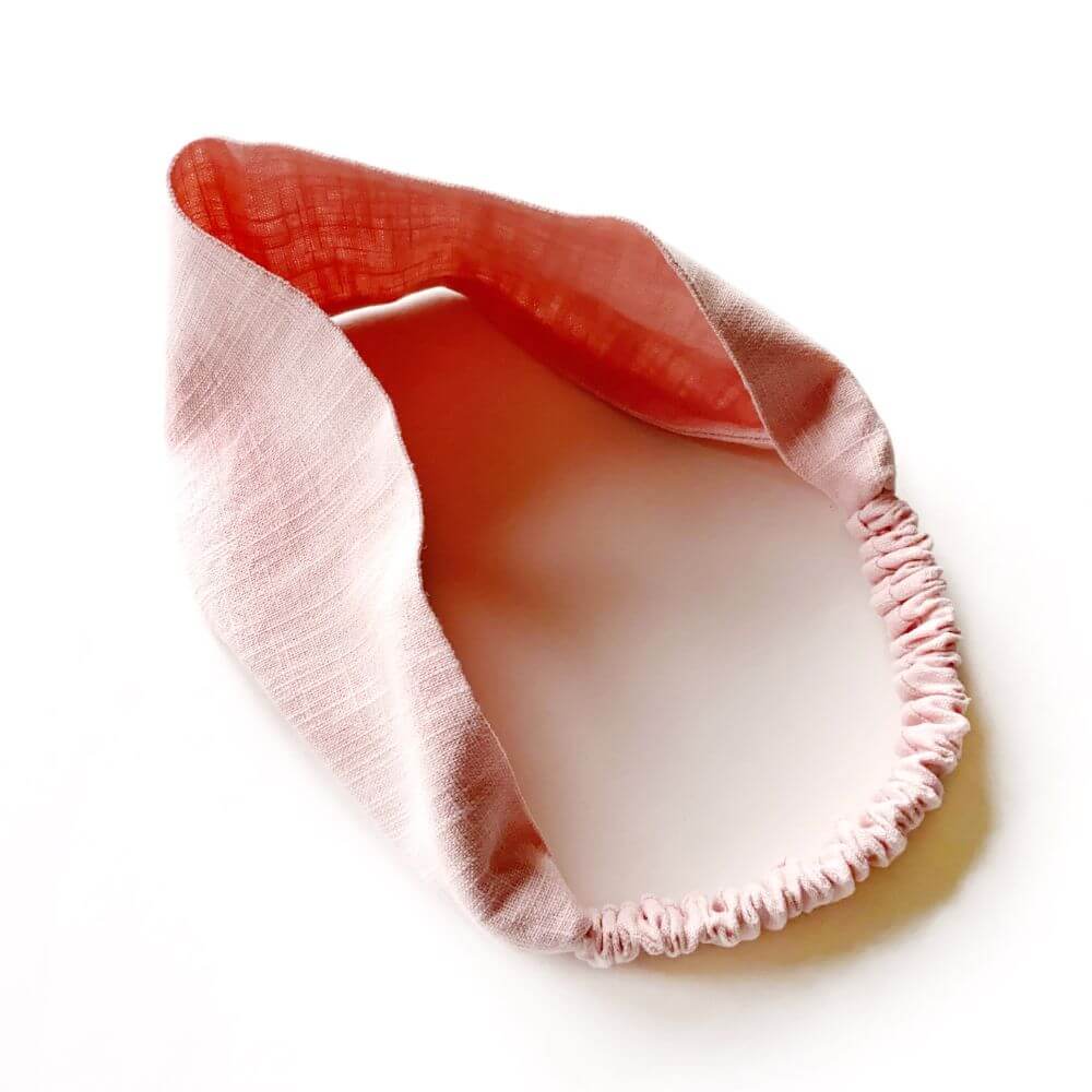Pink linen headband on a white background