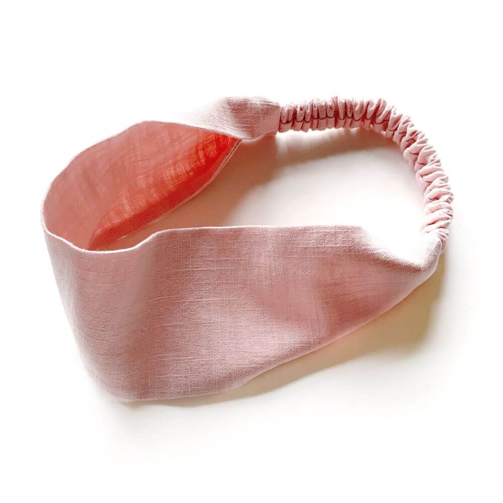 Pink linen headband on a white background