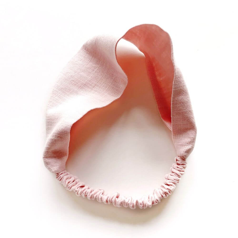 Pink linen headband on a white background