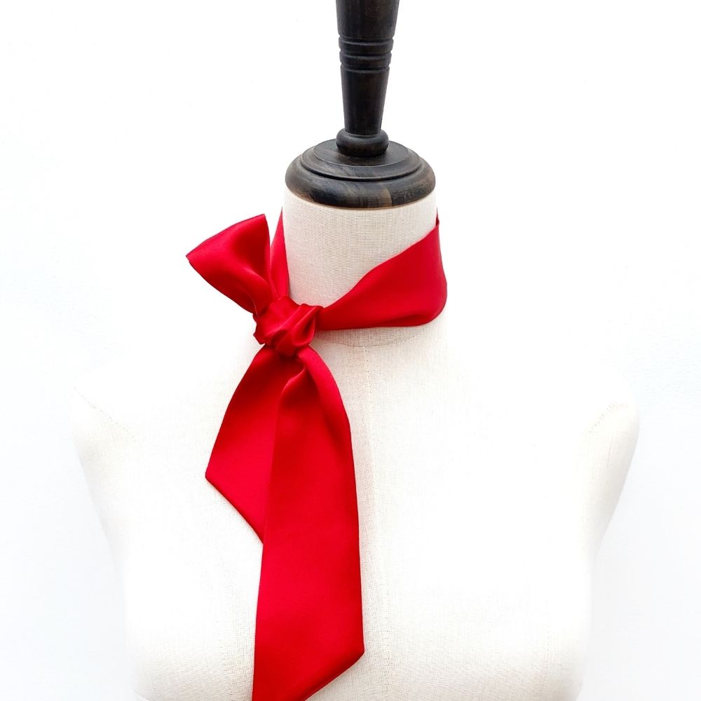 red mulberry silk satin skinny scarf tied around mannequin's neck