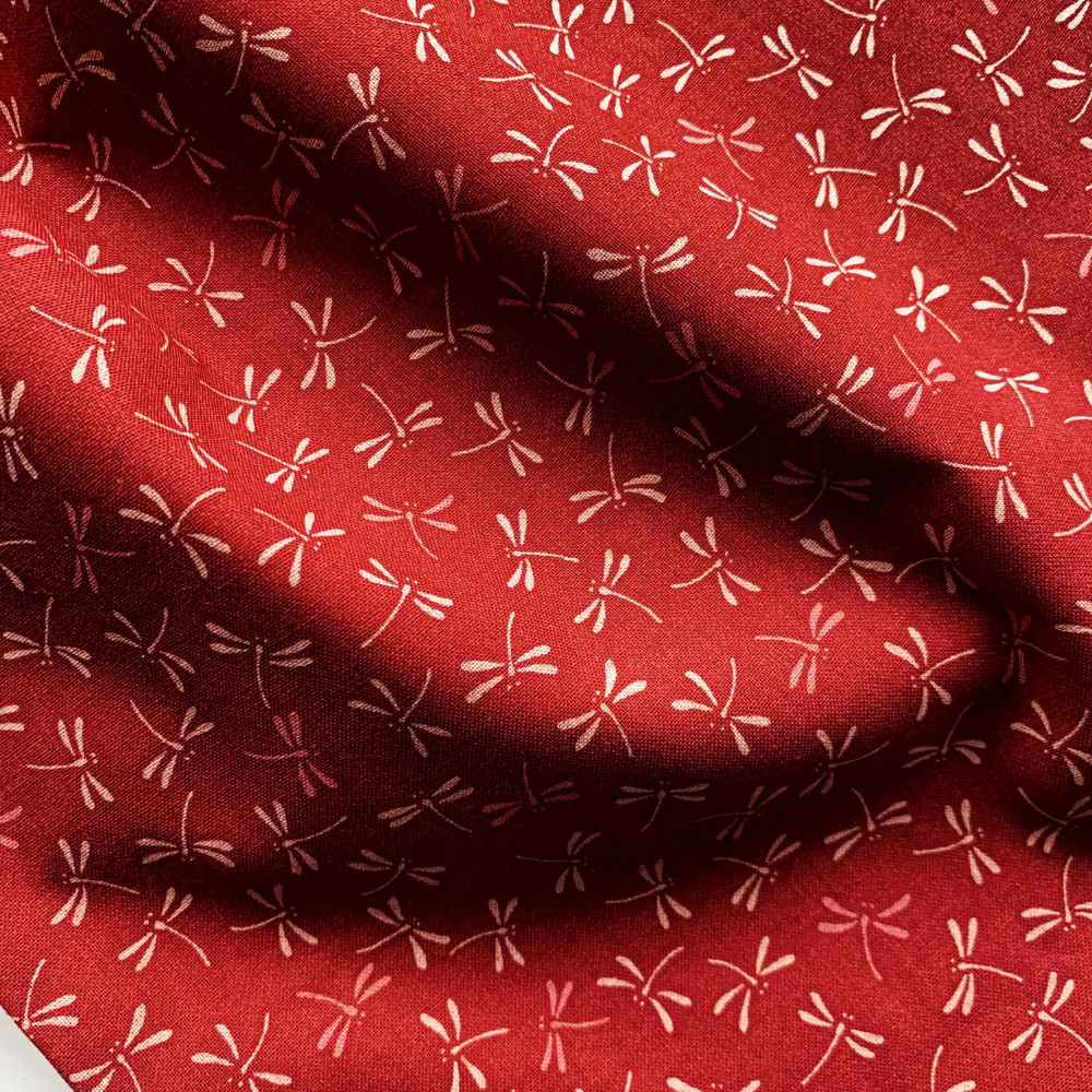 Red fabric with beige dragonfly  pattern