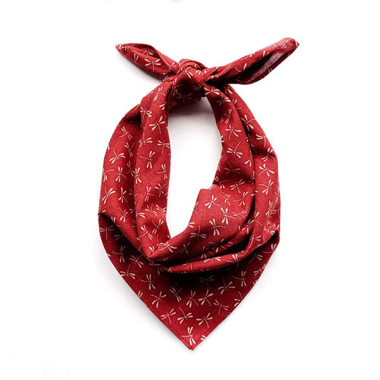 Red bandana with beige dragonfly patterns on a white background