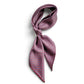 A patterned mulberry silk square scarf tied as a neckerchief, featuring a geometric and small paisley design in red, blue, and white on a white background