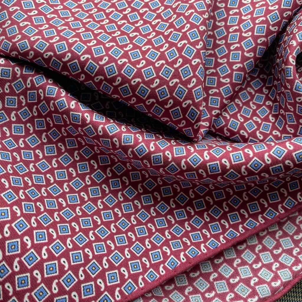 Close-up of a deep red small geometric and paisley print mulberry silk square scarf