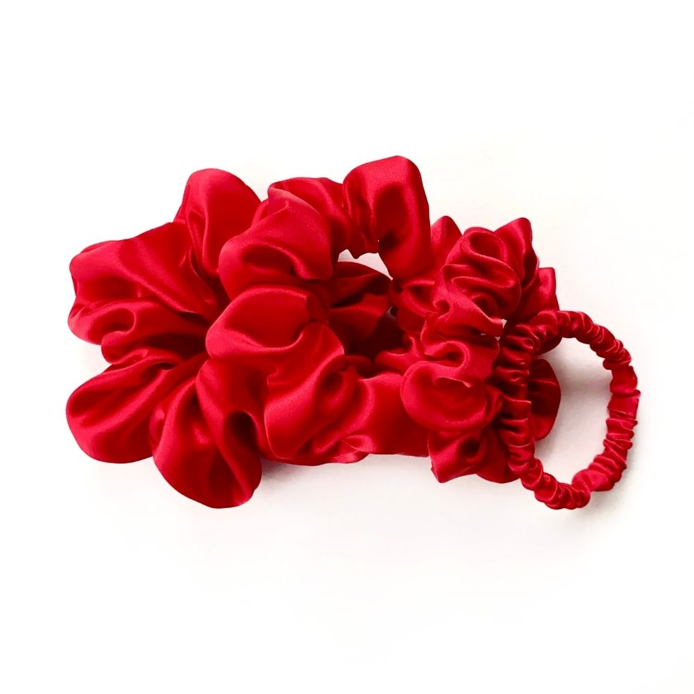set of red mulberry silk satin scrunchies  and hair ties on the white background