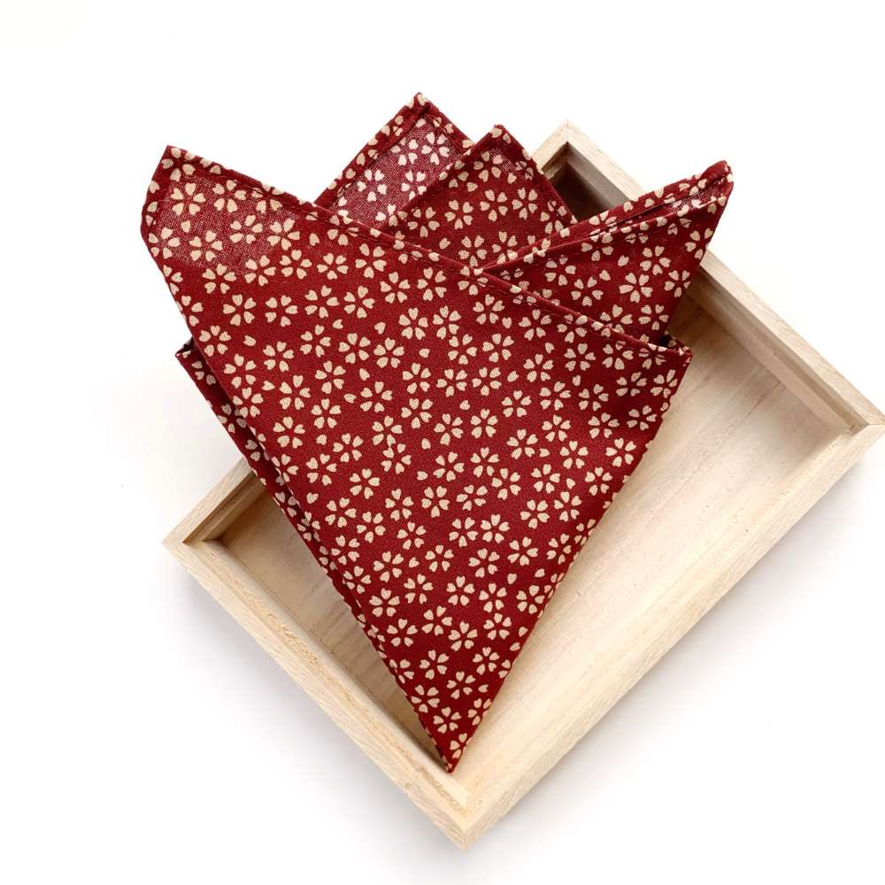 Red cherry blossom floral print Japanese cotton pocket square in a wooden box on a white background