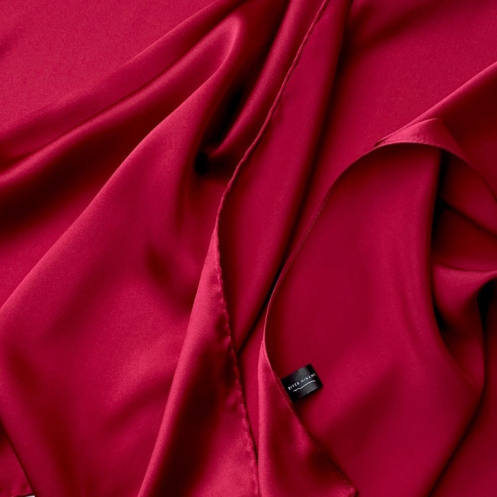Close-up of berry red Mulberry silk satin fabric with smooth sheen