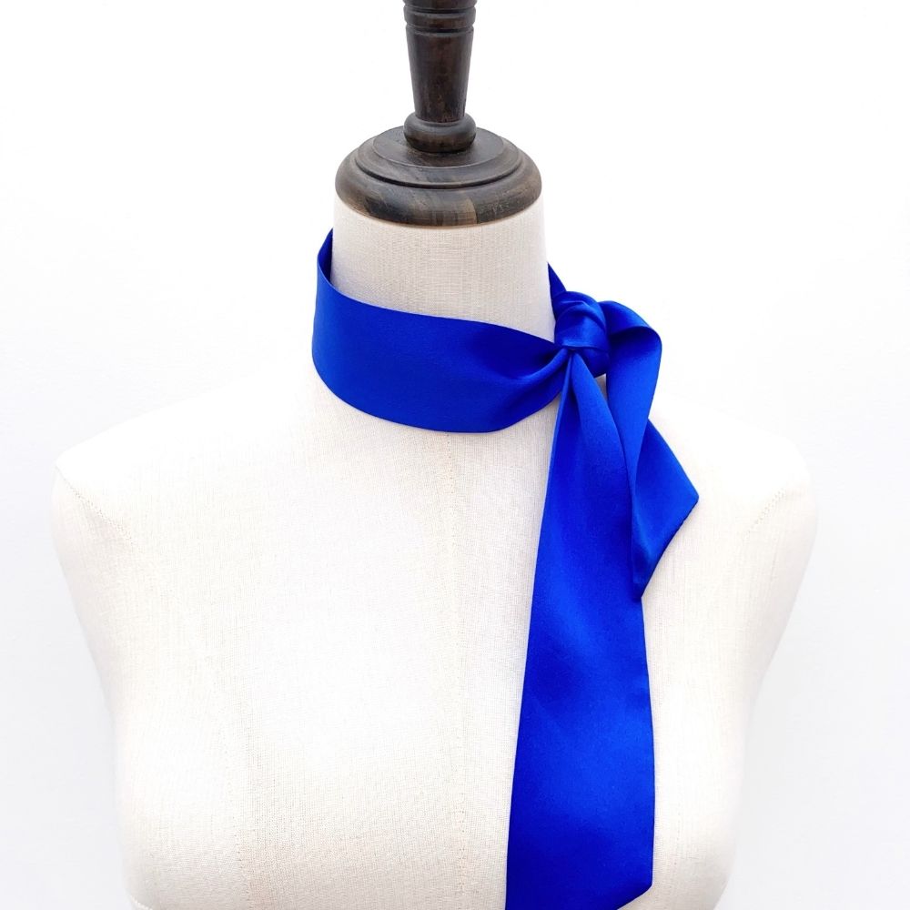 royal blue mulberry silk satin skinny scarf tied around mannequin's neck