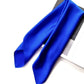 Draped royal blue silk scarf over an open book