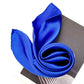 Close-up of royal blue silk scarf rolled into a spiral