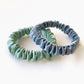 sage green and dusty blue mulberry silk skinny scrunchies and hair ties