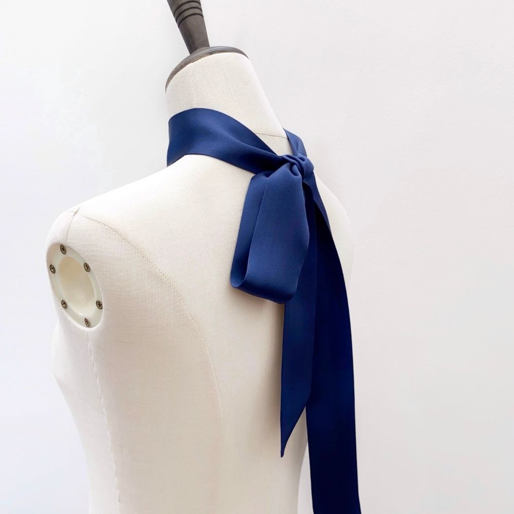 navy blue mulberry silk satin skinny scarf tied around mannequin's neck