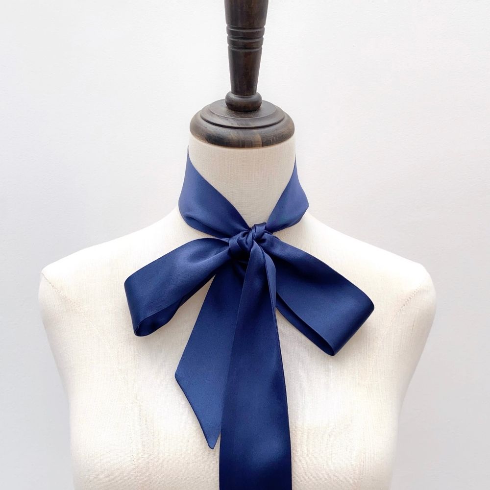 navy blue mulberry silk satin skinny scarf tied around mannequin's neck