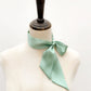mint green mulberry silk satin skinny scarf tied around mannequin's neck