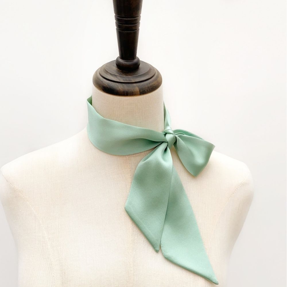mint green mulberry silk satin skinny scarf tied around mannequin's neck