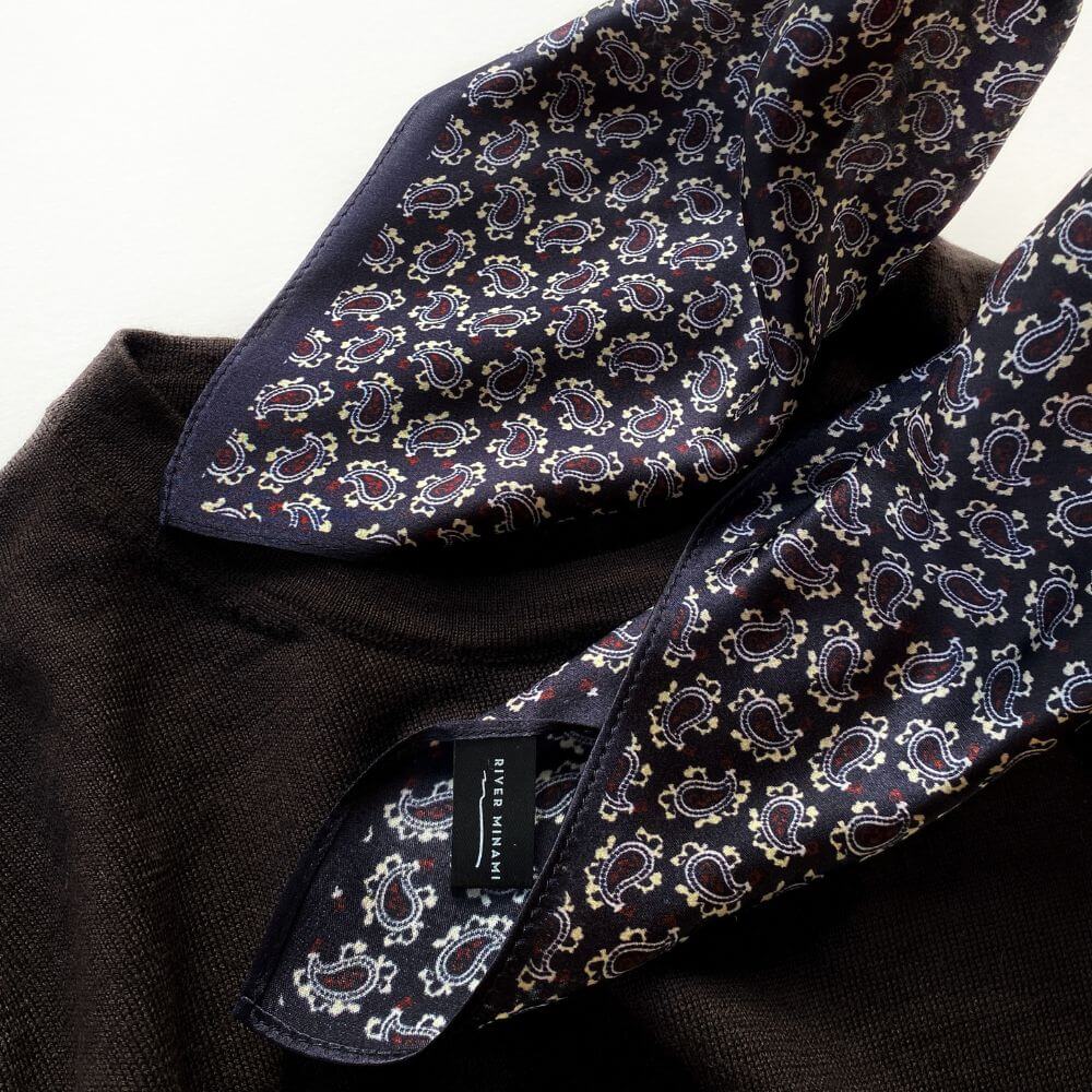 Detailed close-up of mini paisley motifs on dark purple Mulberry silk on a sweater.