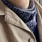 Man wearing dark purple paisley silk scarf as a neckerchief