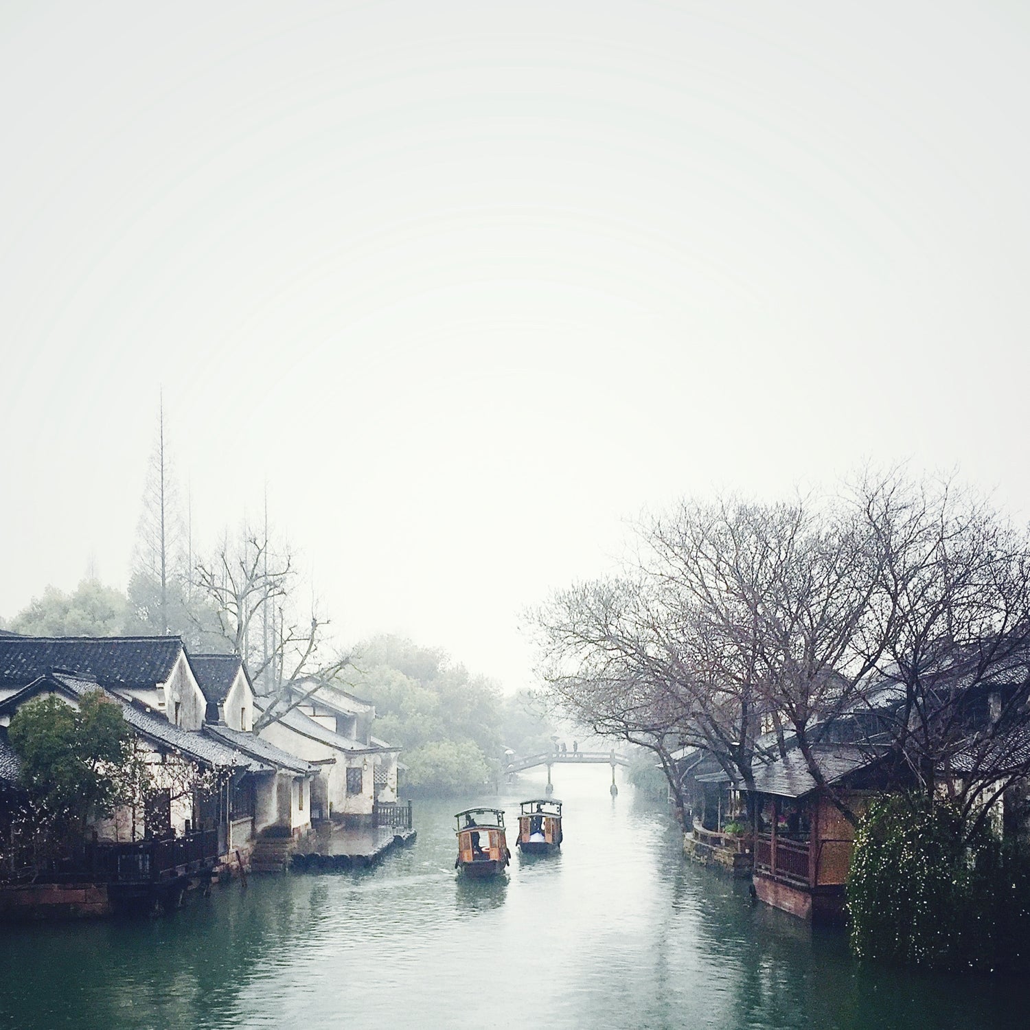  two boats on the river, chinese traditional houses on both sides of the canal.