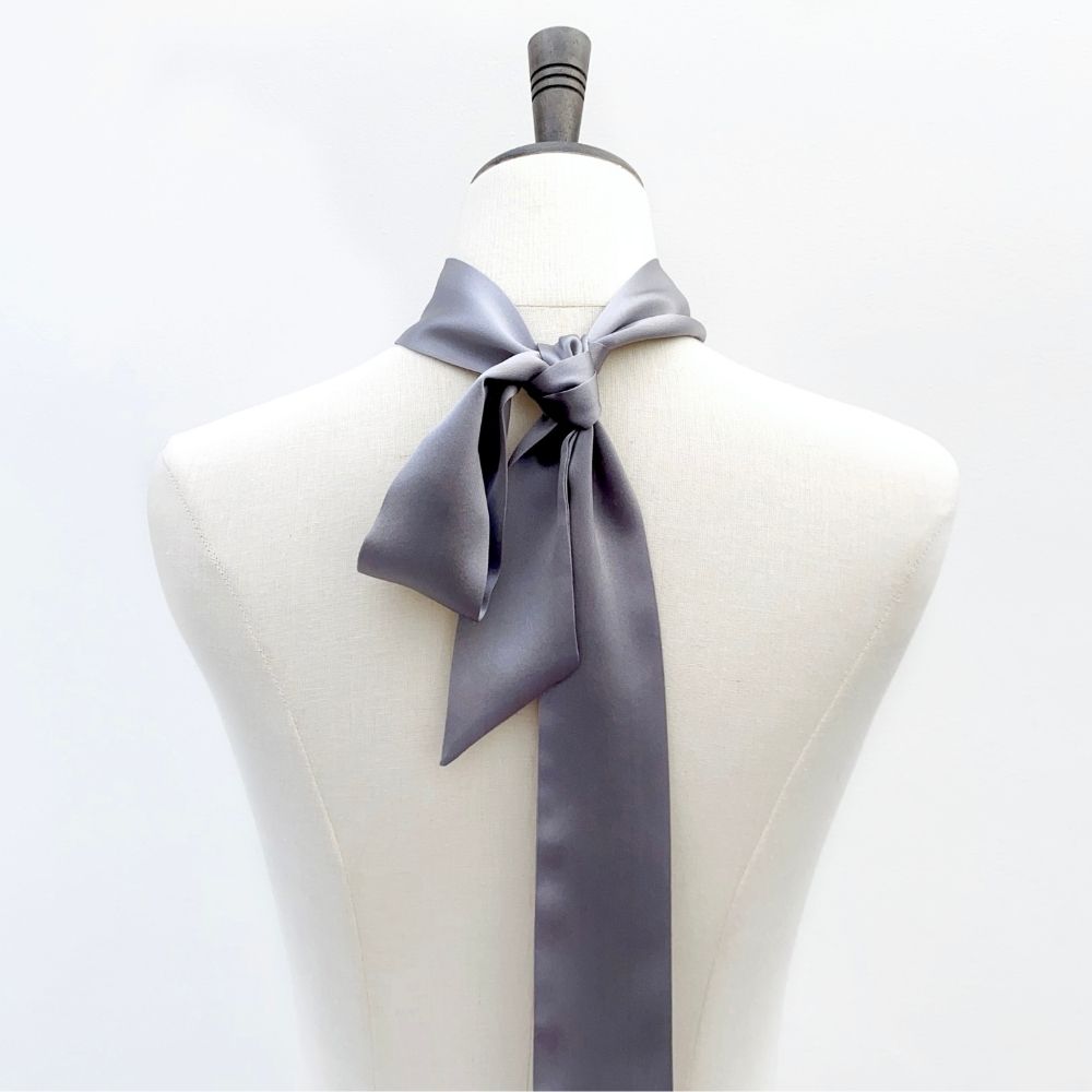grey mulberry silk satin skinny scarf tied around mannequin's neck